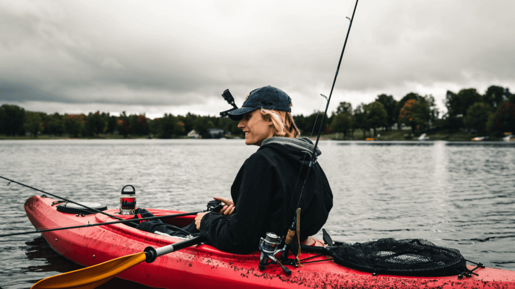 A Person in Black Jacket Riding a Kayak